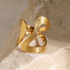 Sculptural asymmetric shape and thread detailing on gold ring