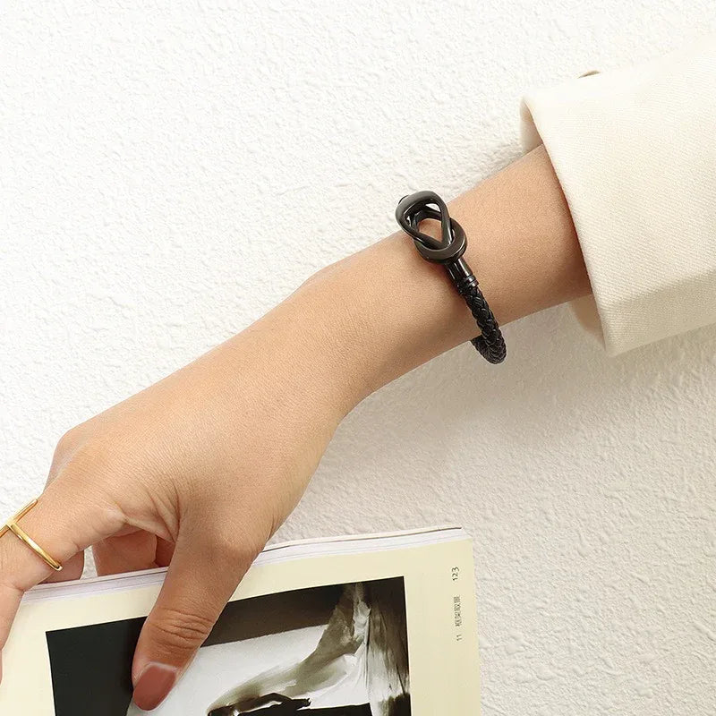 Side angle of interlocking bracelet reflecting warm light and polished finish