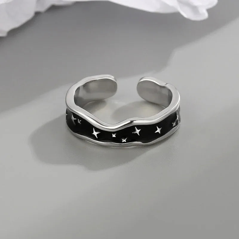 Side profile showing wave curve and star design on open ring