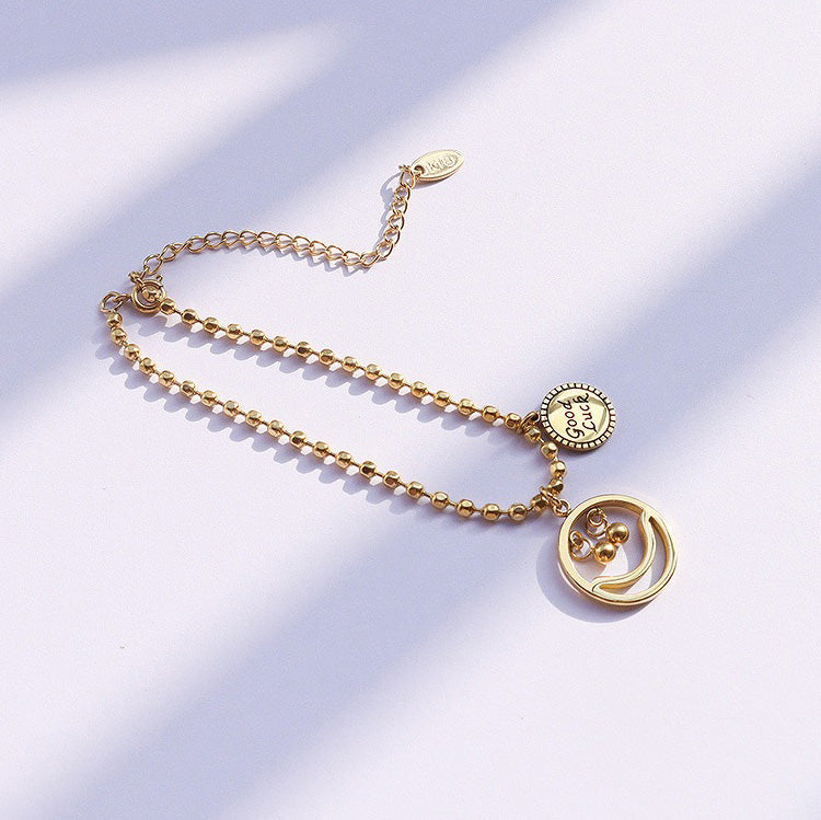 Personalized smiley face design on 18K gold Lucky Vibes bracelet