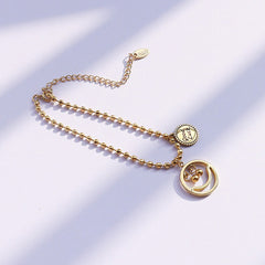 Personalized smiley face design on 18K gold Lucky Vibes bracelet