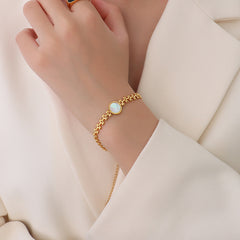 Heart-shaped seashell accent with wheat ear detail on gold bracelet