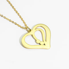 Model wearing silver heart necklace with personalized name detai