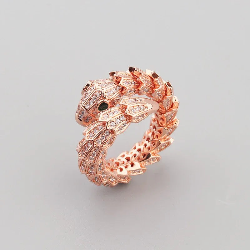 Side angle of serpent ring showing textured curves and gemstone shine