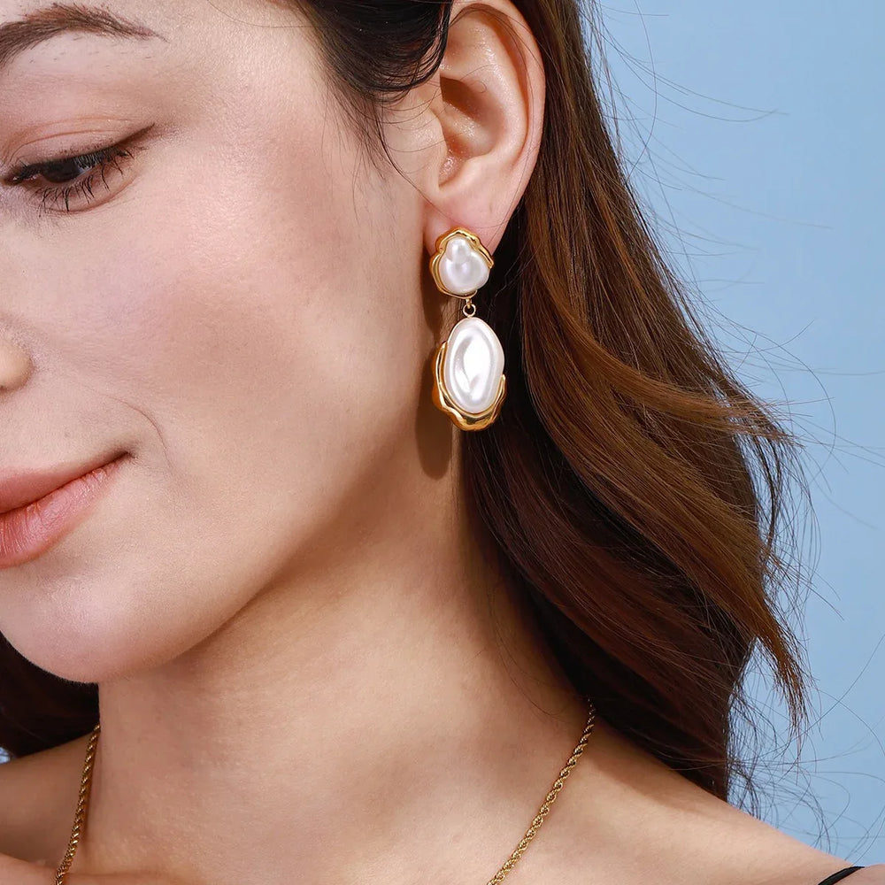 Earrings displayed on a soft beige fabric with natural lighting