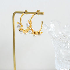 Model wearing vintage pearl flower earrings styled with a formal outfit