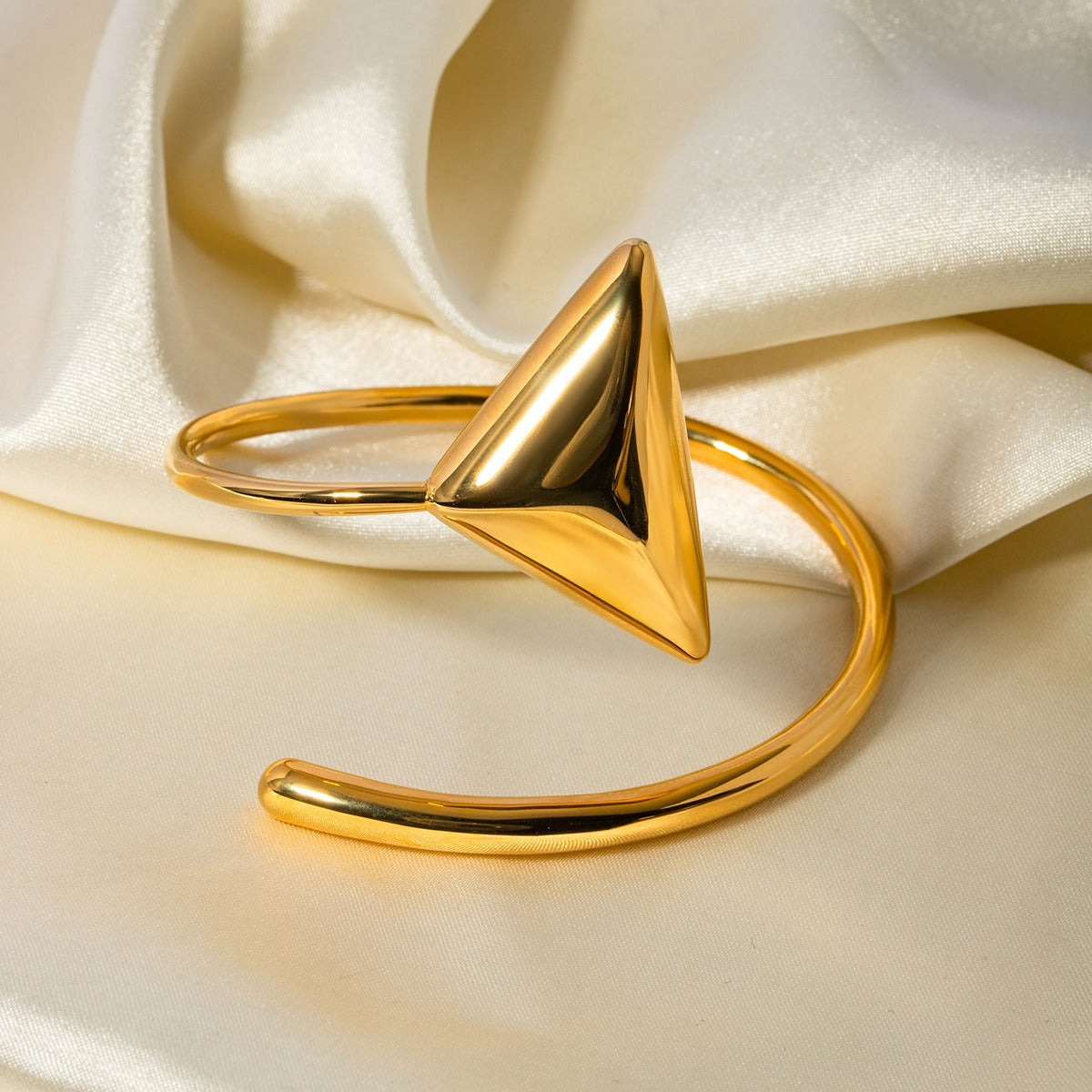 Golden Axis Bracelet featuring bold triangle and coiled band design