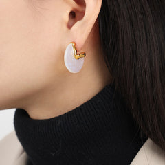 18K gold fan-shaped earrings styled with formal outfi