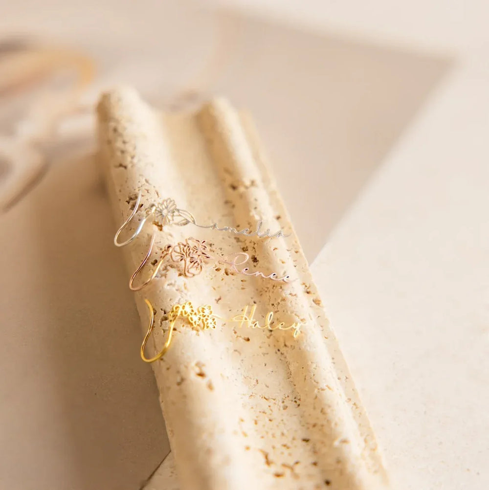 Copper and silver variants of FloraName earrings side by side