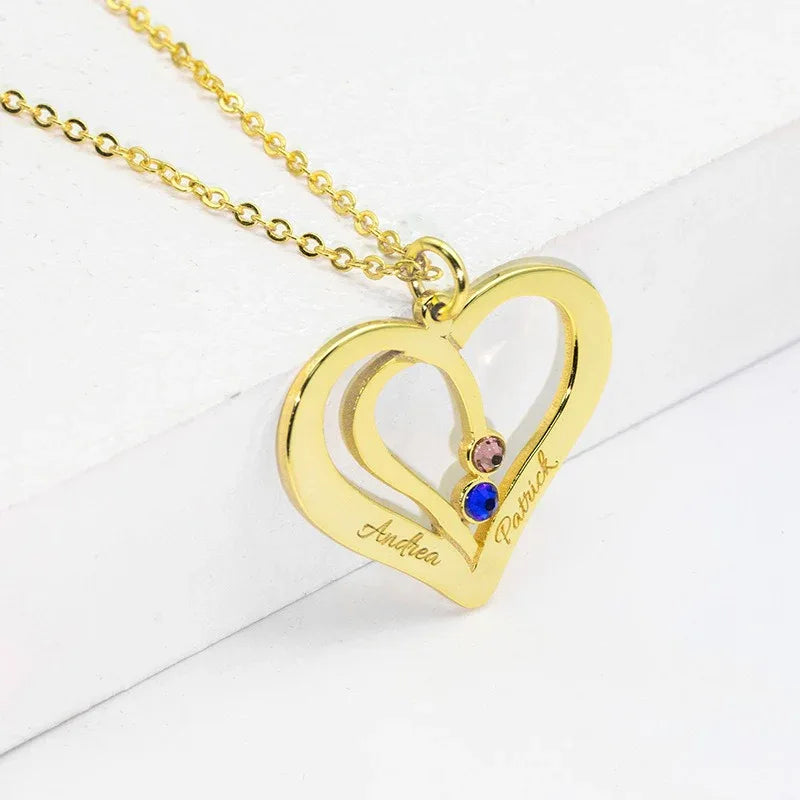 Close-up of engraved name on silver heart pendant necklace