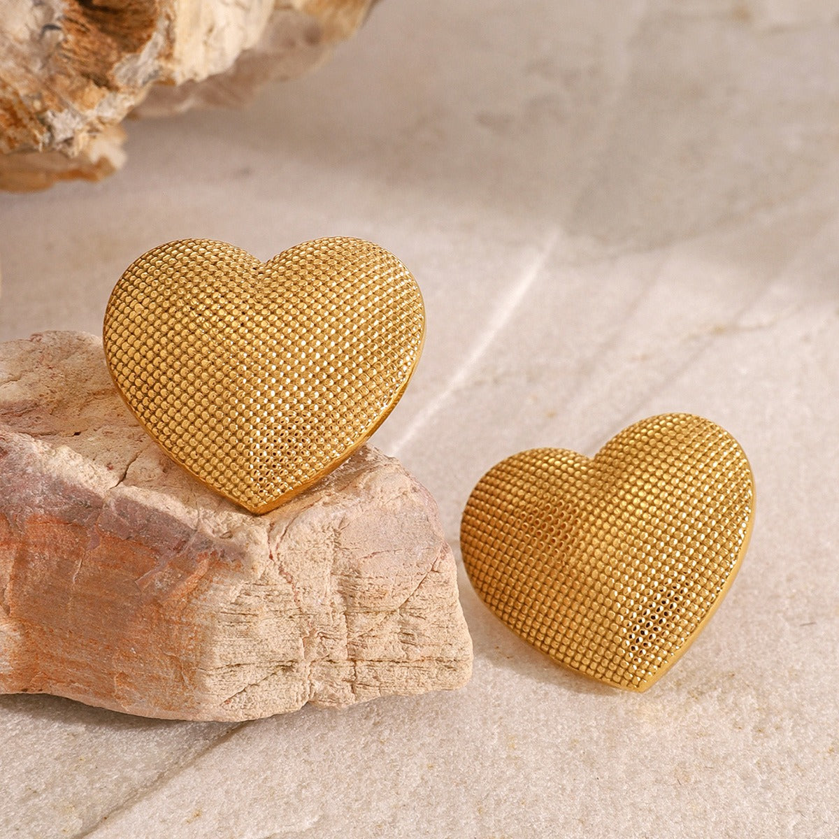 Matching 18K gold heart earrings with sculpted surface finish