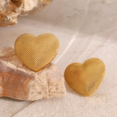 Matching 18K gold heart earrings with sculpted surface finish
