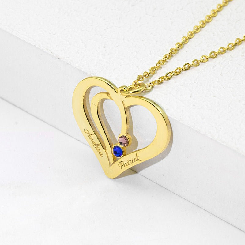 Model wearing silver heart necklace with personalized name detai