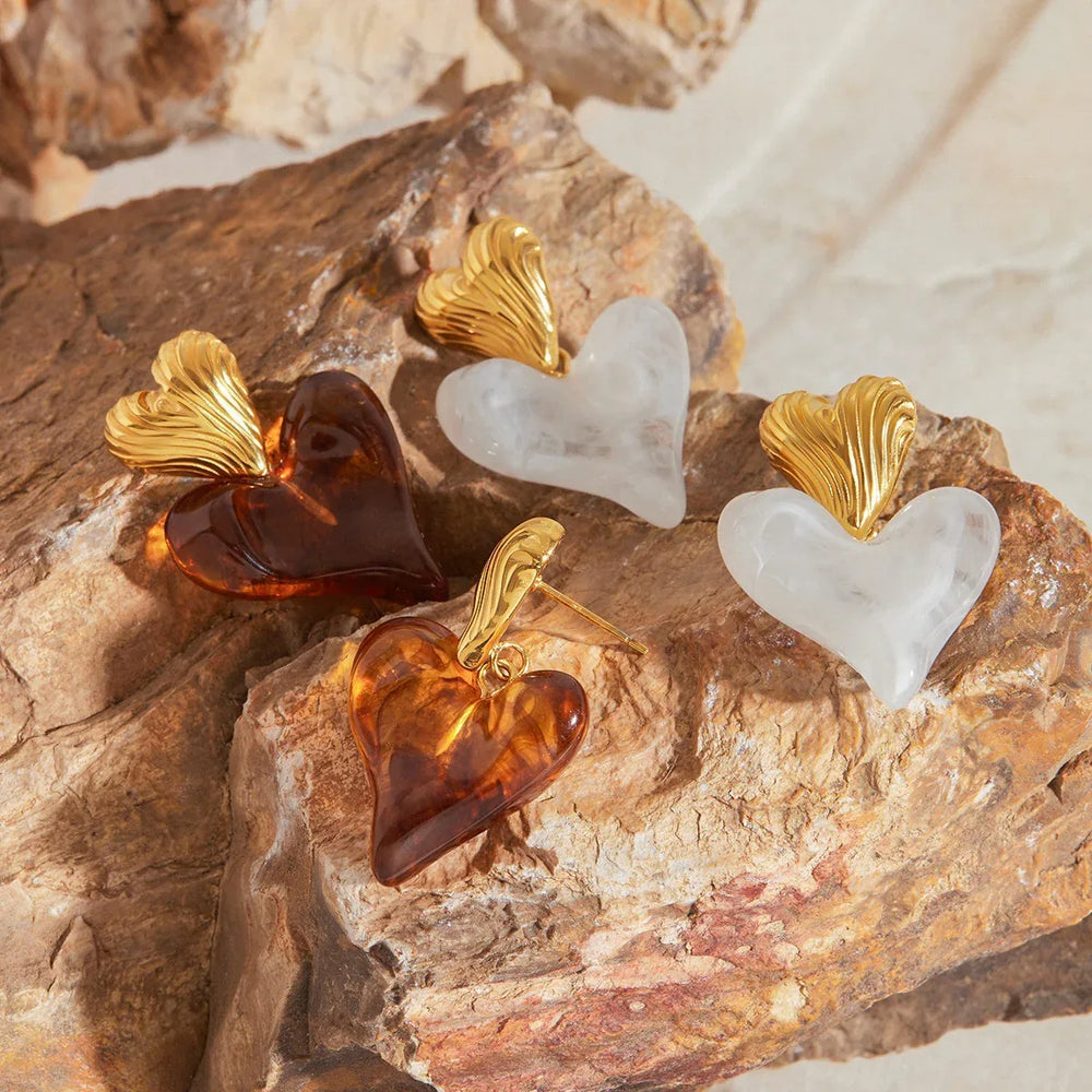 Women’s heart-shaped gold earrings with smooth romantic silhouette