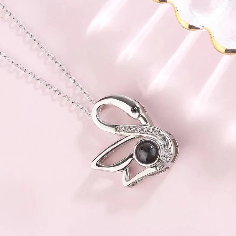 Personalized necklace projecting couple photo through light
