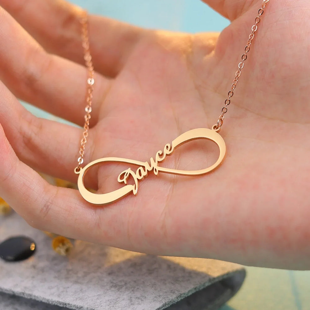 Side profile of silver infinity pendant showing engraved personalization