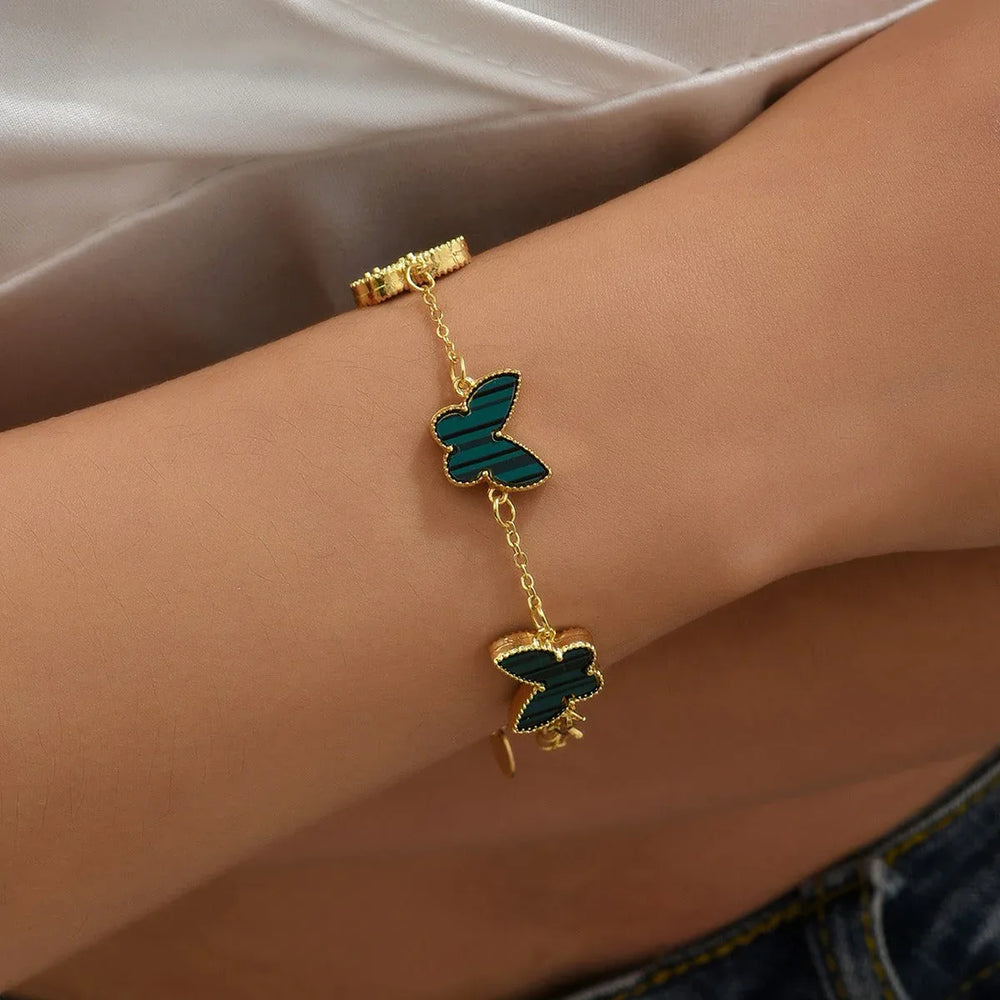 Wings of Fortune – 18K Gold Butterfly and Clover Pendant Bracelet