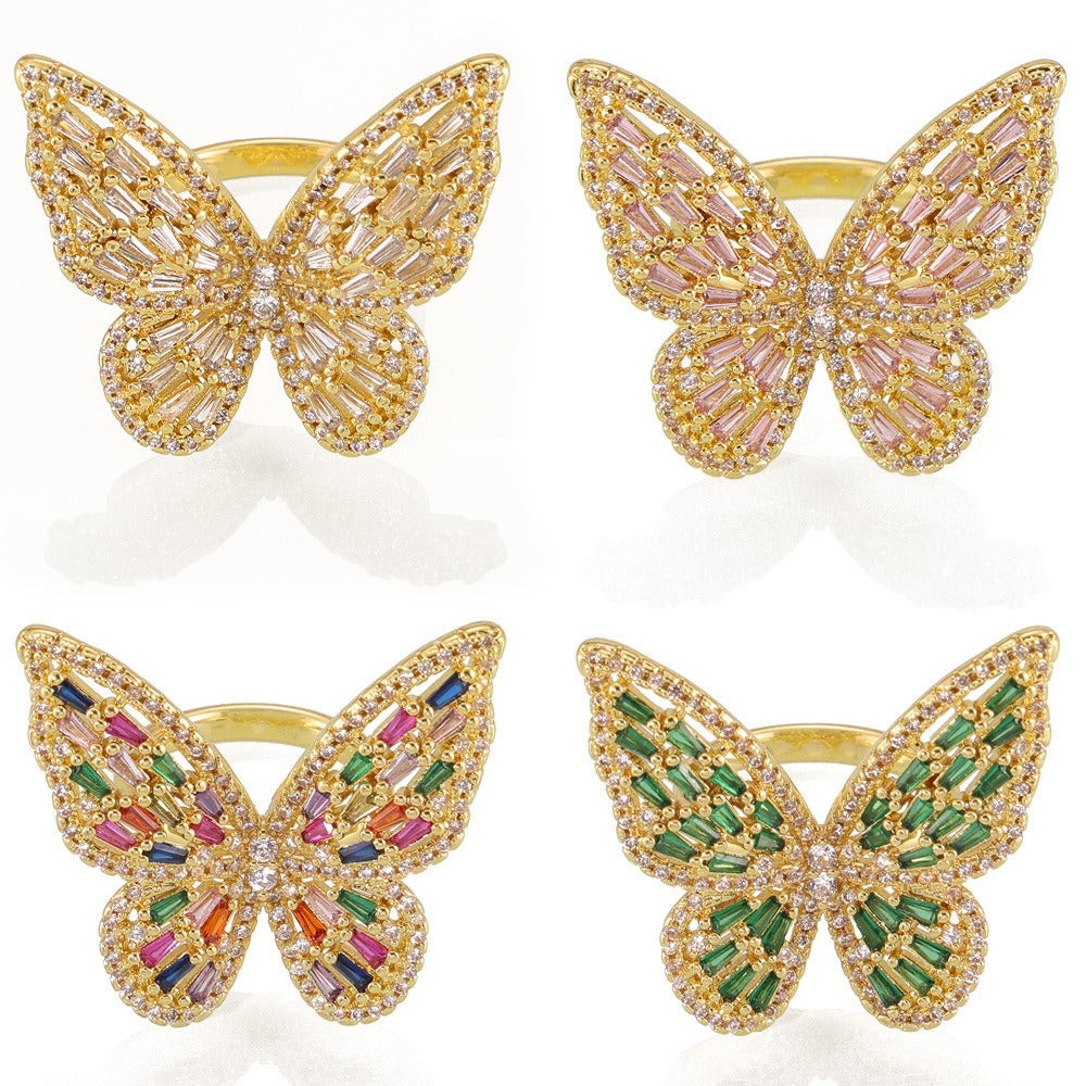 Butterfly zircon ring displayed on soft neutral background under soft light