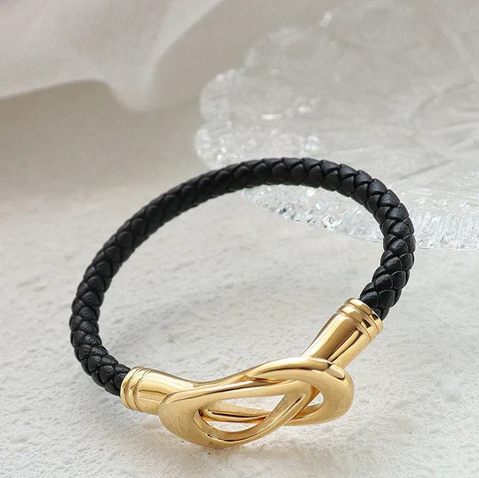 Liora 18K gold bracelet with interlocking oval buckle design on white surface