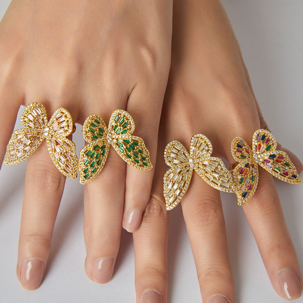 Close-up of butterfly motif with precision-cut zircon accents on gold ring
