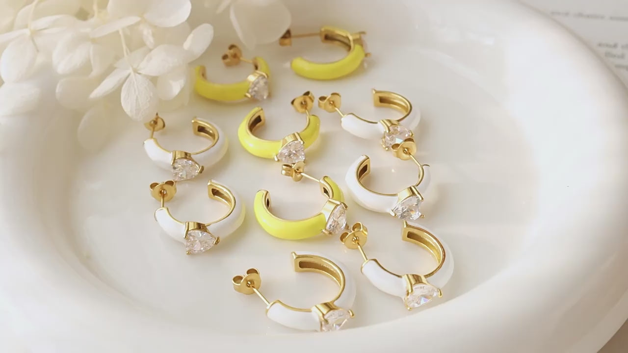 Side angle showing curve and gem detail of gold C-shaped earrings