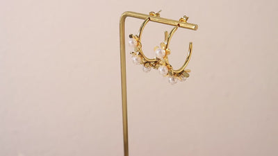 Model wearing vintage pearl flower earrings styled with a formal outfit